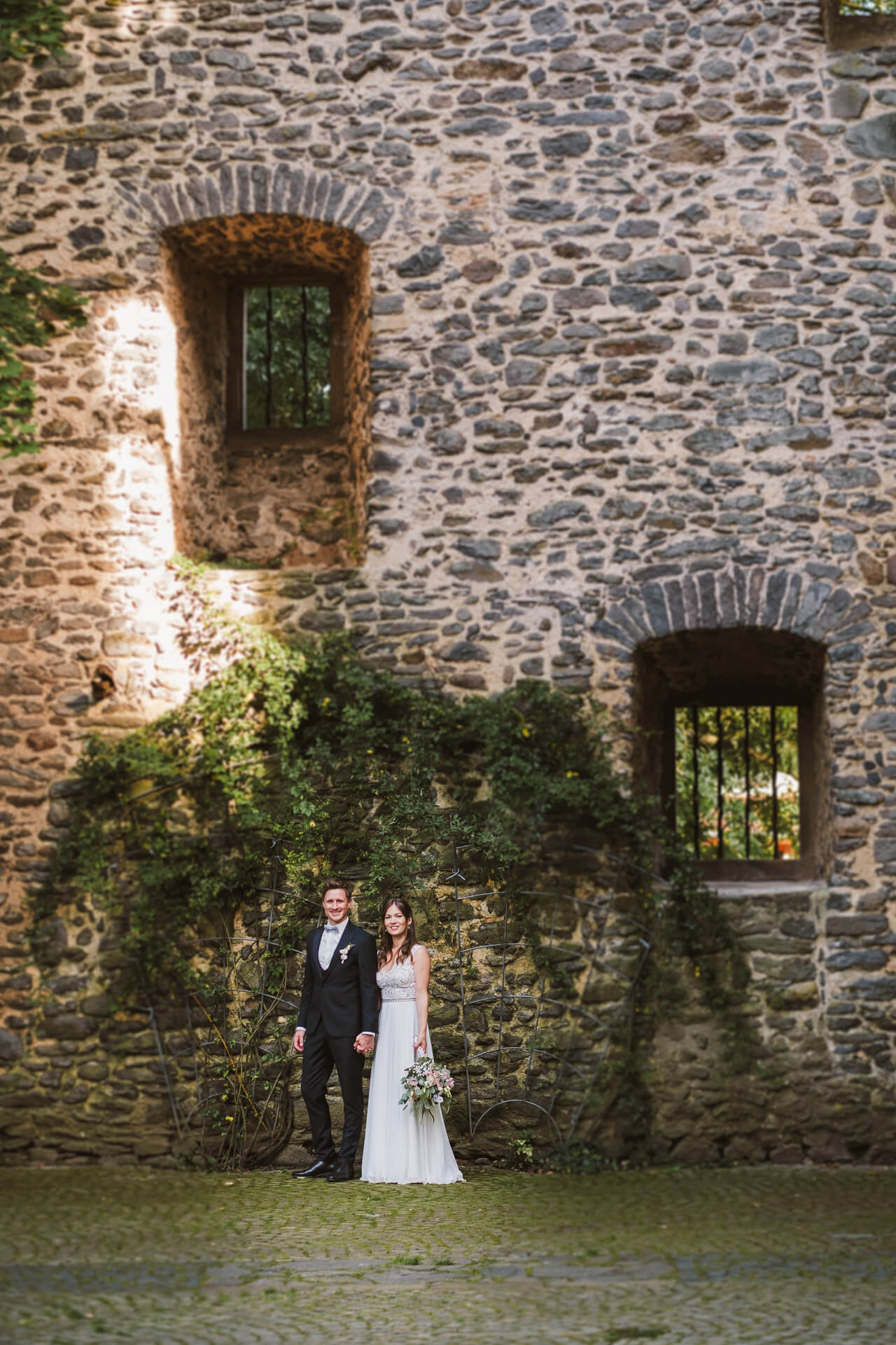 brautpaar im innenhoff der hochzeitslocation schloss romrod in hessen